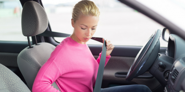 A Women in Pink Shirt wearing seat belt