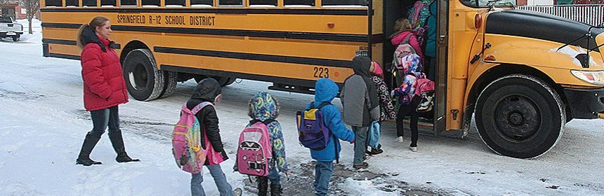 students in a line before bus