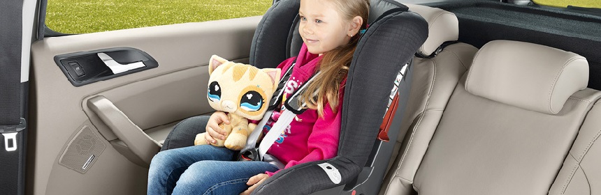 A child sitting in car with seat belts