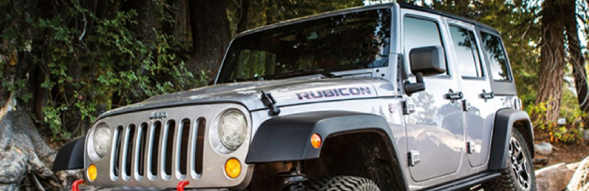 Jeep Rubicon Is Riding Through And Rugged Terrain To The Rocks.