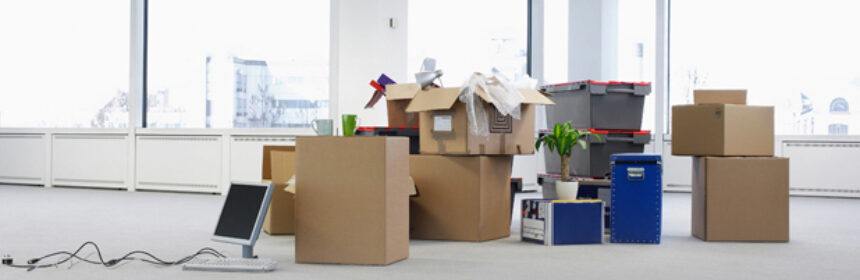 A picture depicting Office relocation displaying a Desktop computer, furniture and cartons